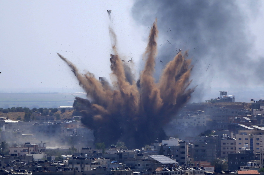 Smoke rises following Israeli airstrikes on a building in Gaza City, Thursday, May 13, 2021. Weary Palestinians are somberly marking the end of the Muslim holy month of Ramadan, as Hamas and Israel traded more rockets and airstrikes and Jewish-Arab violence raged across Israel.