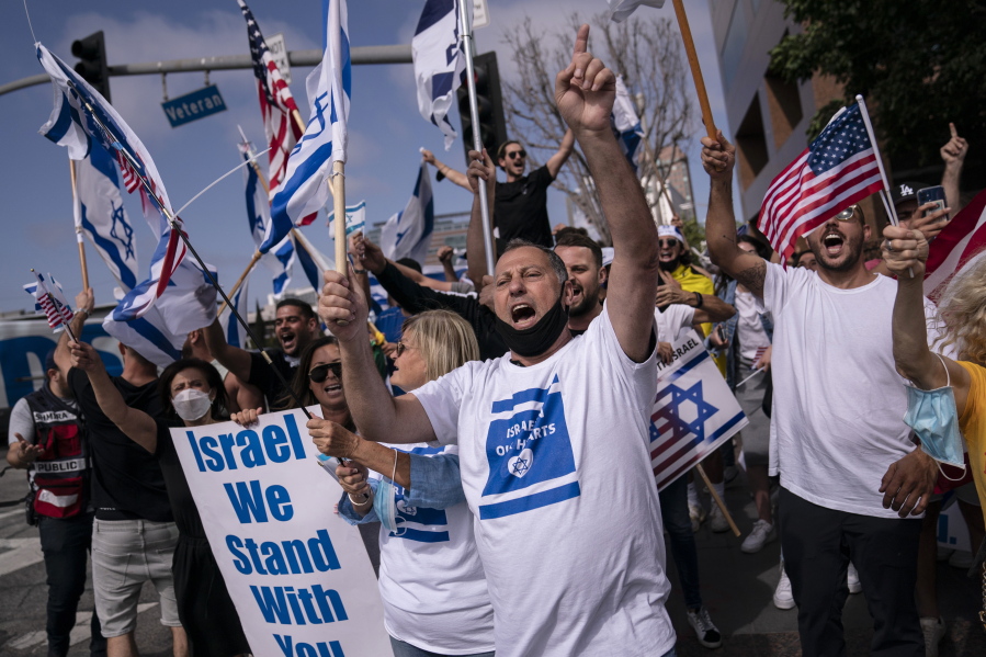 FILE - Pro-Israel supporters chant slogans during a rally in support of Israel outside the Federal Building in Los Angeles, Wednesday, May 12, 2021. A larger debate is playing out nationwide among many U.S. Jews who are divided over how to respond to the violence and over the disputed boundaries for acceptable criticism of Israeli policies. (AP Photo/Jae C.