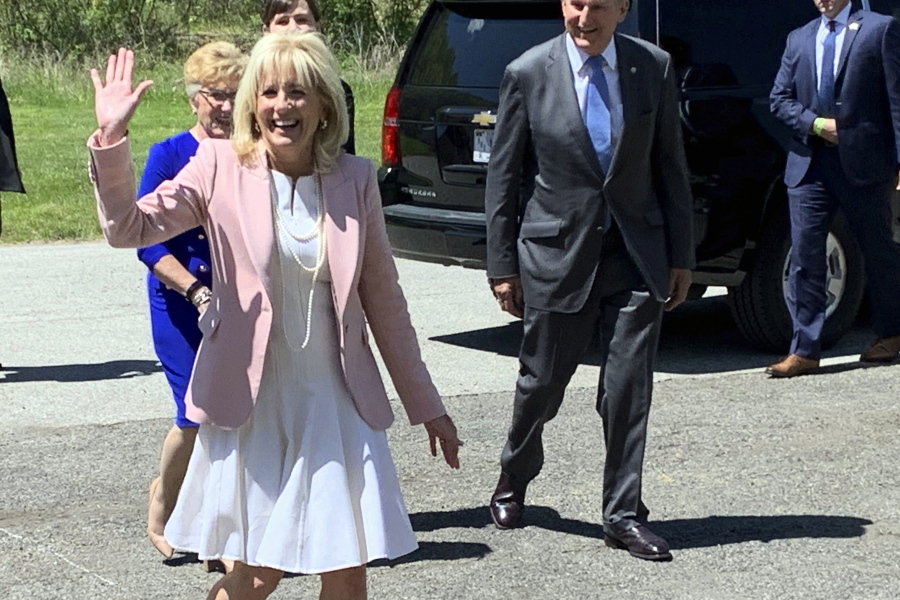 First lady Jill Biden arrives at a vaccination clinic Thursday, May 13, 2021, at a high school in Charleston, W.Va. Behind her are U.S. Sen. Joe Manchin of West Virginia and his wife, Gayle Manchin.