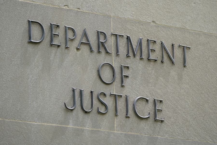 This May 4, 2021, photo shows a sign outside the Robert F. Kennedy Department of Justice building in Washington. The Trump Justice Department secretly seized the phone records of three Washington Post reporters who covered the federal investigation into ties between Russia and Donald Trump's campaign, the newspaper said Friday, May 7.