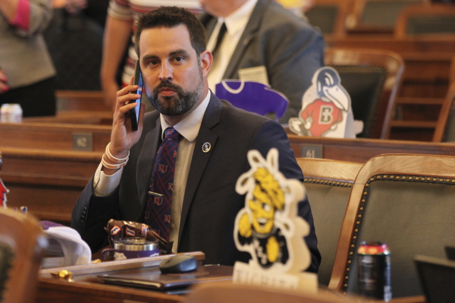 In this photo from Monday, May 3, 2021, Kansas state Rep. Mark Samsel, R-Wellsville, talks on his cellphone ahead of the House's daily session, at the Statehouse in Topeka, Kan. Samsel has been charged with three counts of misdemeanor battery over incidents involving two teenage students while he was substitute teaching.