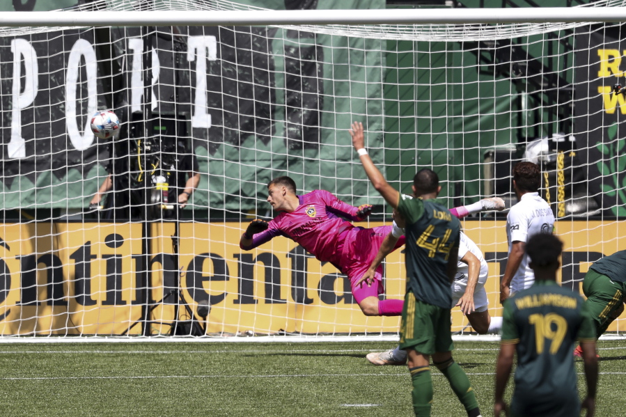 A ball kicked by Portland Timbers forward Felipe Mora (9) makes it past LA Galaxy goalkeeper Jonathan Bond (1) during the second half of an MLS soccer match, Saturday, May 22, 2021, in Portland, Ore. Portland Timbers won 3-0.