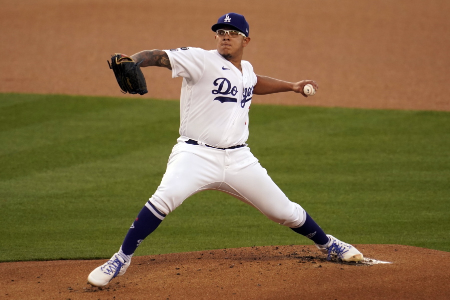Los Angeles Dodgers starting pitcher Julio Urias throws to a Seattle Mariners batter during the first inning of a baseball game Wednesday, May 12, 2021, in Los Angeles.