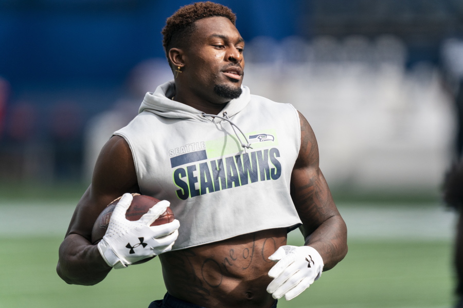 FILE - Seattle Seahawks wide receiver DK Metcalf runs with the ball during warmups before an NFL football game against the Dallas Cowboys in Seattle, in this Sunday, Sept. 27, 2020, file photo. Metcalf has accepted an invitation to run the 100 meters at the USA Track and Field Golden Games in Walnut, California.