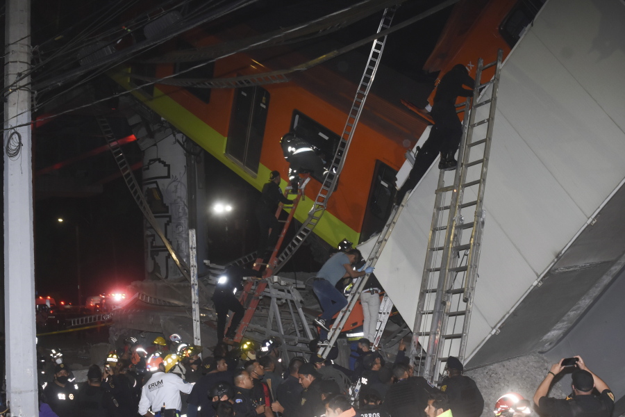 Mexico City fire fighters and rescue personnel work to recover victims from a subway accident after a section of Line 12 of the subway collapsed in Mexico City, Monday, May 3, 2021. The section passing over a road in southern Mexico City collapsed Monday night, dropping a subway train, trapping cars and causing at least 50 injuries and several dead, authorities said.
