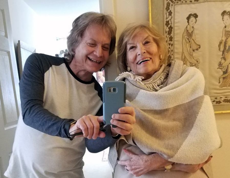 Leland Stein, left, takes a photo with his mother Sondra Green in her apartment in New York in  2018.
