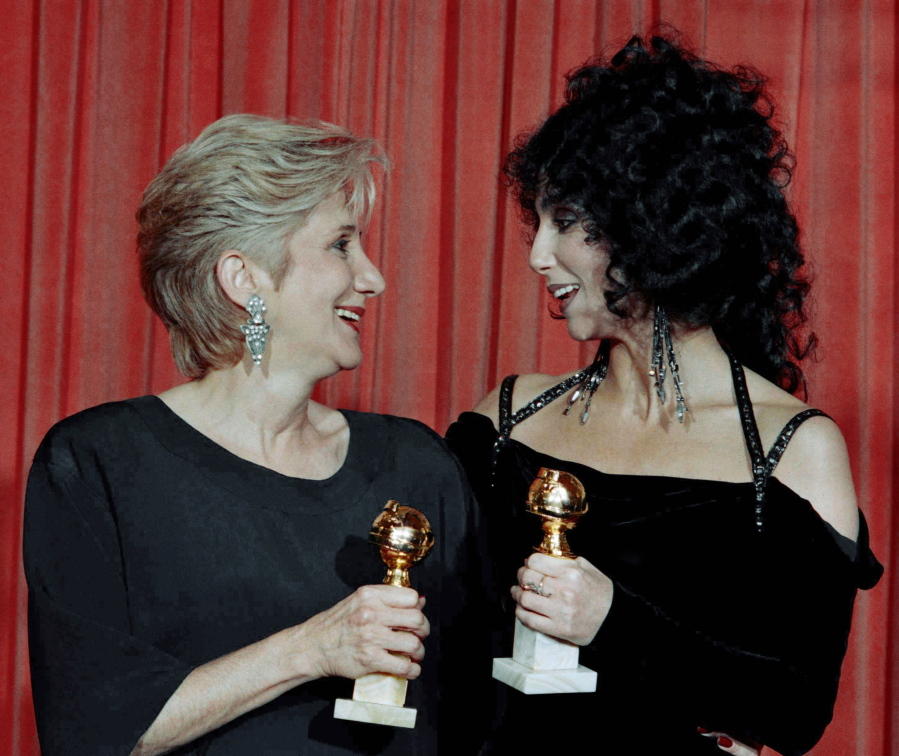 FILE - In this Jan. 24, 1988 file photo, Actress Olympia Dukakis, winner of a Golden Globe for "Best Performance in a Supporting Role" and Cher, winner of the "Best Performance by an Actress in a musical or comedy", hold the awards they received for performances in the hit movie "Moonstruck" at the Beverly Hilton Hotel. Olympia Dukakis, the veteran stage and screen actress whose flair for maternal roles helped her win an Oscar as Cher's mother in the romantic comedy "Moonstruck," has died. She was 89.