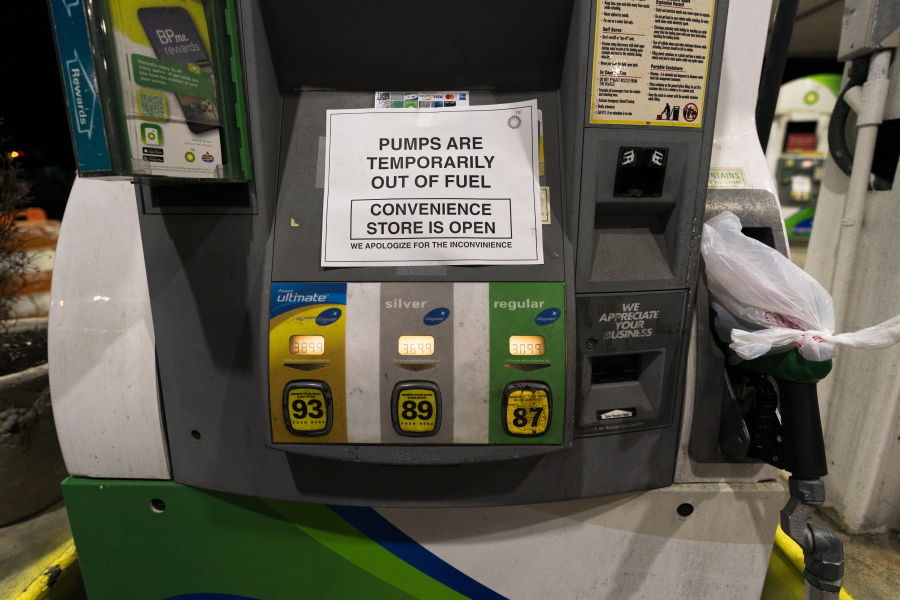 A gas pump at a gas station in Silver Spring, Md., is out of service, notifying customers they are out of fuel, late Thursday, May 13, 2021. Motorists found gas pumps shrouded in plastic bags at tapped-out service stations across more than a dozen U.S. states Thursday while the operator of the nation's largest gasoline pipeline reported making "substantial progress" in resolving the computer hack-induced shutdown responsible for the empty tanks.
