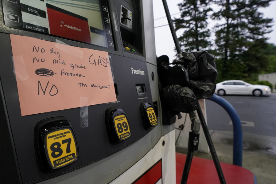 A hand written sign is posted on a gas pump, showing that the service station is out of all grades of fuel Wednesday, May 12, 2021, in Charlotte, N.C.  Several gas stations in the Southeast reported running out of fuel, primarily because of what analysts say is unwarranted panic-buying among drivers, as the shutdown of a major pipeline by hackers entered its fifth day.