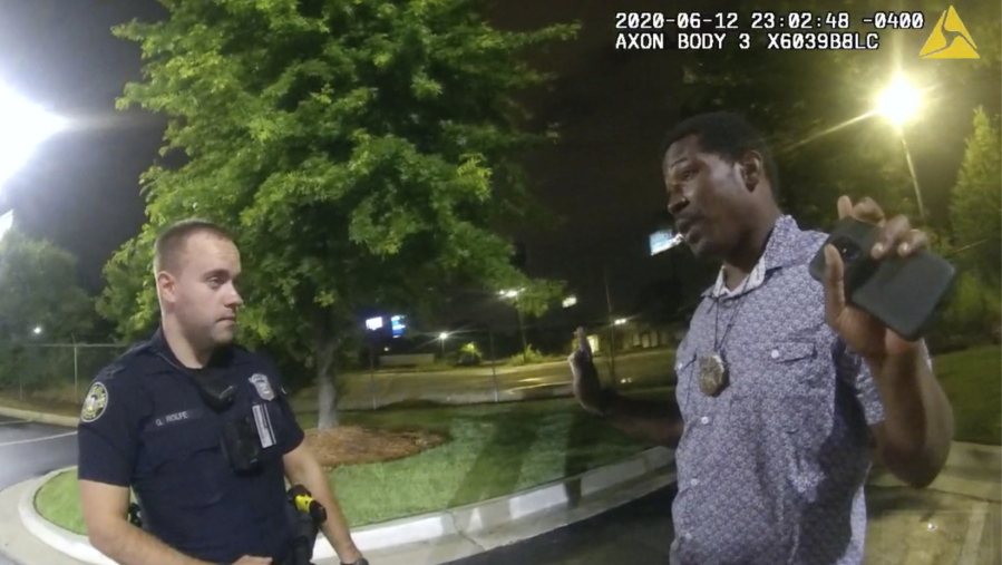 FILE - In this June 12, 2020, file photo from a screen grab taken from body camera video provided by the Atlanta Police Department Rayshard Brooks, right, speaks with Officer Garrett Rolfe, left, in the parking lot of a Wendy's restaurant, in Atlanta. Former Atlanta Police Officer, Rolfe's attorney said Thursday, April 22, 2021, that his client didn't get a chance to defend himself before he was fired for fatally shooting Brooks, a Black man who had been running away from two white officers after he resisted arrest and fired a stun gun at one of them.