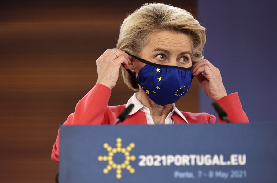 European Commission President Ursula von der Leyen puts on her protective face mask at the conclusion of a media conference at an EU summit in Porto, Portugal, Saturday, May 8, 2021. On Saturday, EU leaders held an online summit with India's Prime Minister Narendra Modi, covering trade, climate change and help with India's COVID-19 surge.