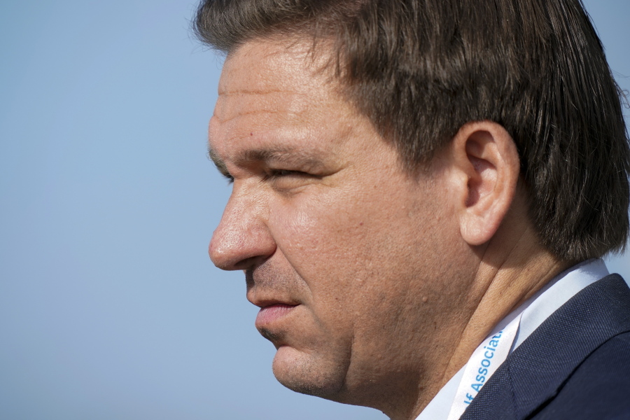 FILE - In this Saturday, May 8, 2021, file photo, Gov. Ron DeSantis, of Florida, watches the foursome matches during the Walker Cup golf tournament, in Juno Beach, Fla. DeSantis is pushing the Biden administration to approve a program he says would save tens of millions of dollars by importing drugs from Canada.