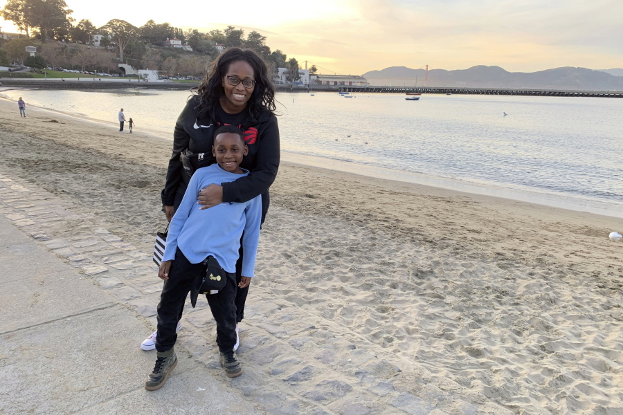 In this photo provided by Tanya Hayles, Hayles poses with her son Jackson, 7, in this undated photo. Hayles, founder of Black Moms Connection, an online network of more than 16,000 Black mothers with chapters across North America and Asia, said she has noticed discussions among members about how remote learning has allowed Black mothers to better shield their children from racism.