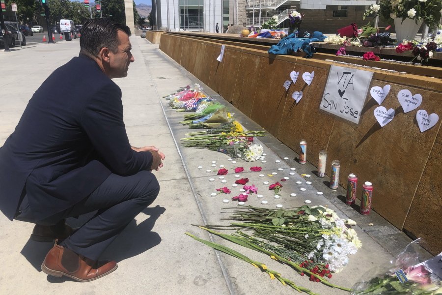 San Jose Mayor Sam Liccardo stops to view a makeshift memorial for the rail yard shooting victims in front of City Hall in San Jose, Calif., on Thursday, May 27, 2021. An employee opened fire Wednesday at a California rail yard, killing eight people before taking his own life as law enforcement rushed in, authorities said, marking the latest attack in a year that has seen a sharp increase in mass killings as the nation emerges from coronavirus restrictions.