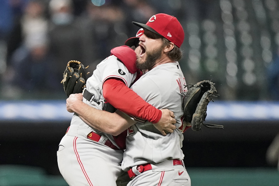 Cincinnati Reds starting pitcher Wade Miley, right, is congratulated by catcher Tucker Barnhart after pitching a no-hitter against the Cleveland Indians in a baseball game, Friday, May 7, 2021, in Cleveland.