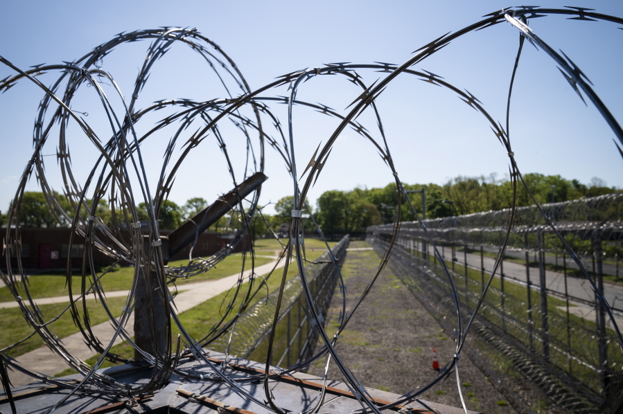 Razor wire surrounds the perimeter fencing at the former Arthur Kill Correctional Facility, Tuesday, May 11, 2021, in the Staten Island borough of New York. The facility was purchased by Broadway Stages in 2017 and has been transformed into a film and television studio. Much of the prison was preserved as a set, lending authenticity to scenes in productions. Five other sound stages are being built on the 69-acre site, giving production companies the ability to shoot entire projects.