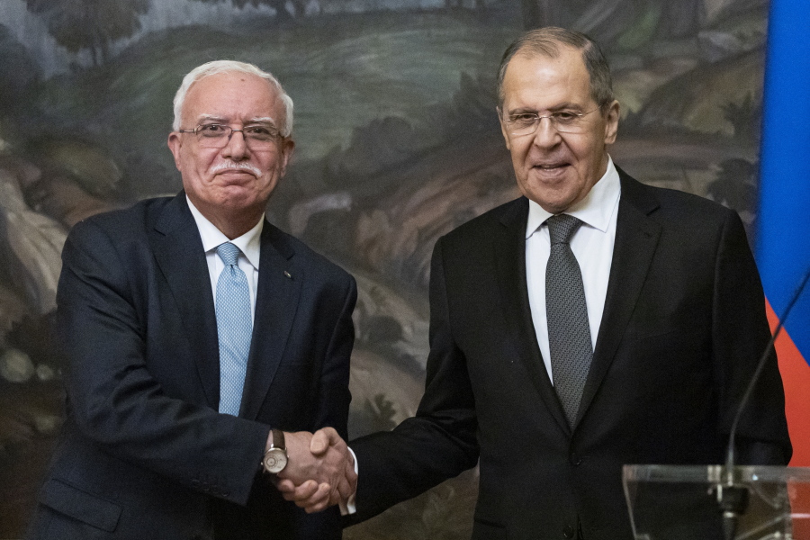 Russian Foreign Minister Sergey Lavrov, right, and Palestinian Foreign Minister Riyad Al-Maliki shake hands as they leave a joint news conference following their talks in Moscow, Russia, Wednesday, May 5, 2021.