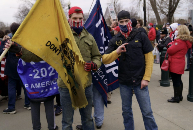 An image of Jonathanpeter Allen Klein and Matthew Leland Klein, which prosecutors say shows Jonathanpeter doing a Proud Boys hand signal the day before the Capitol riot.