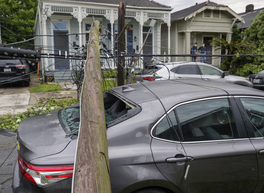 A utility pole rests on a 2020 Toyota Camry smashing the back window after powerful storms rolled through the city overnight, in New Orleans Wednesday, May 12, 2021.