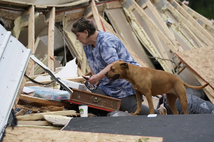 Vickie Savell looks through her belongings amid the remains of her new mobile home early Monday, May 3, 2021, in Yazoo County, Miss. Multiple tornadoes were reported across Mississippi on Sunday, causing some damage but no immediate word of injuries. (AP Photo/Rogelio V.
