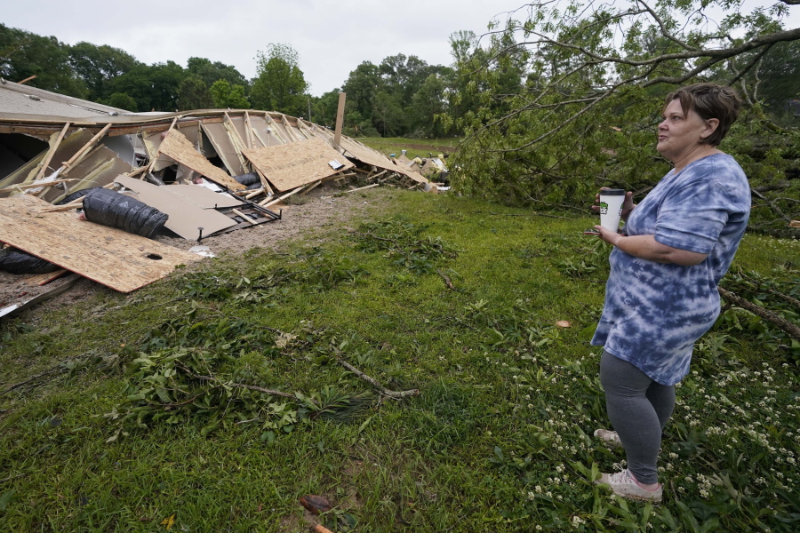 Vickie Savell looks at the remains of her new mobile home early Monday, May 3, 2021, in Yazoo County, Miss. Multiple tornadoes were reported across Mississippi on Sunday, causing some damage but no immediate word of injuries. (AP Photo/Rogelio V.
