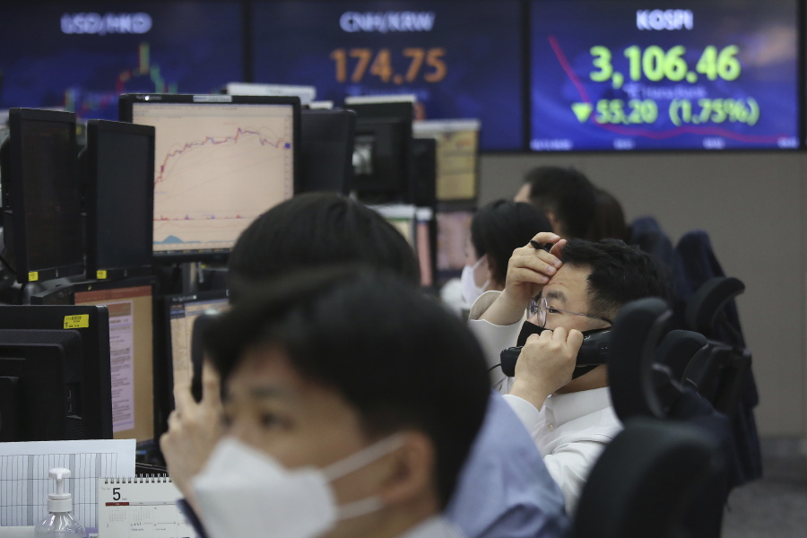 A currency trader talks on the phone at the foreign exchange dealing room of the KEB Hana Bank headquarters in Seoul, South Korea, Thursday, May 13, 2021. Asian stock markets followed Wall Street lower for a second day Thursday after unexpectedly strong U.S. consumer price rises fueled worries inflation might drag on an economic recovery.