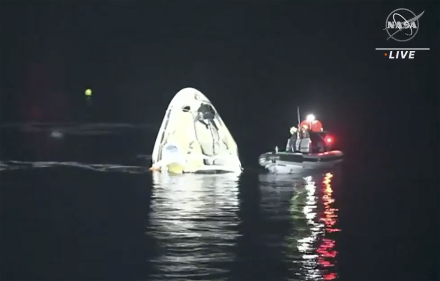 In this image made from NASA TV video, the SpaceX Dragon capsule floats after landing in the Gulf of Mexico near the Florida Panhandle early Sunday, May 2, 2021. SpaceX returned four astronauts from the International Space Station on Sunday, making the first U.S. crew splashdown in darkness since the Apollo 8 moonshot.