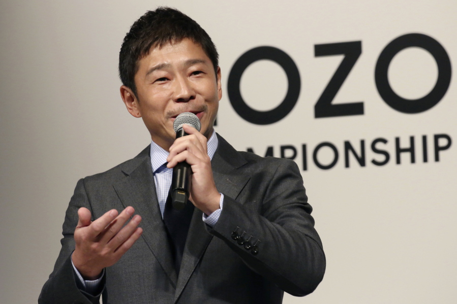 FILE - In this Nov. 20, 2018, file photo, Zozo Chief Executive Yusaku Maezawa speaks during a press conference on the PGA Tour in Tokyo.  The Japanese fashion tycoon who's booked a SpaceX ride to the moon is going to try out the International Space Station first.  Maezawa announced Thursday, May 13, 2021,  that he's bought two seats on a Russian Soyuz capsule.