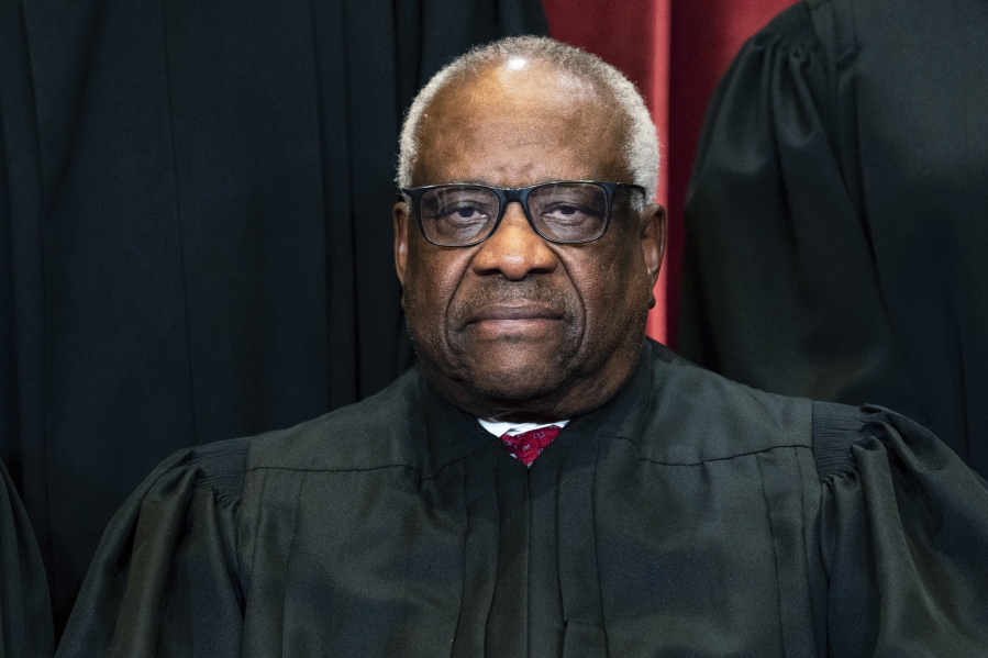 Associate Justice Clarence Thomas sits during a group photo at the Supreme Court in Washington, Friday, April 23, 2021.