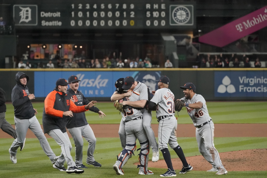 Detroit Tigers starting pitcher Spencer Turnbull, center right, hugs catcher Eric Haase as teammates rush in after Turnbull threw a no-hitter against the Seattle Mariners in a baseball game Tuesday, May 18, 2021, in Seattle. The Tigers won 5-0. (AP Photo/Ted S.