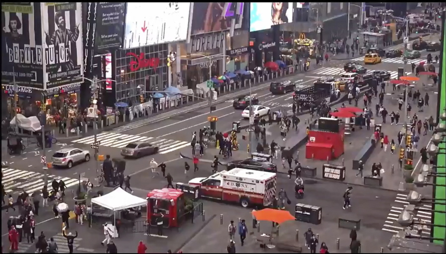 In this image taken from video by the FDNY, pedestrians hurry away from the scene of a shooting in Times Square, Saturday, May 8, 2021, in New York. New York City police say three innocent bystanders including a 4-year-old girl who was toy shopping have been shot in Times Square and officers are looking for suspects. All the victims are expected to recover.