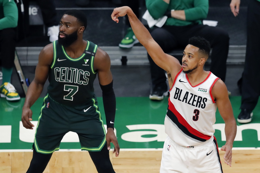 Portland Trail Blazers' CJ McCollum (3) shoots a 3-pointer against Boston Celtics' Jaylen Brown (7) during the second half of an NBA basketball game, Sunday, May 2, 2021, in Boston.
