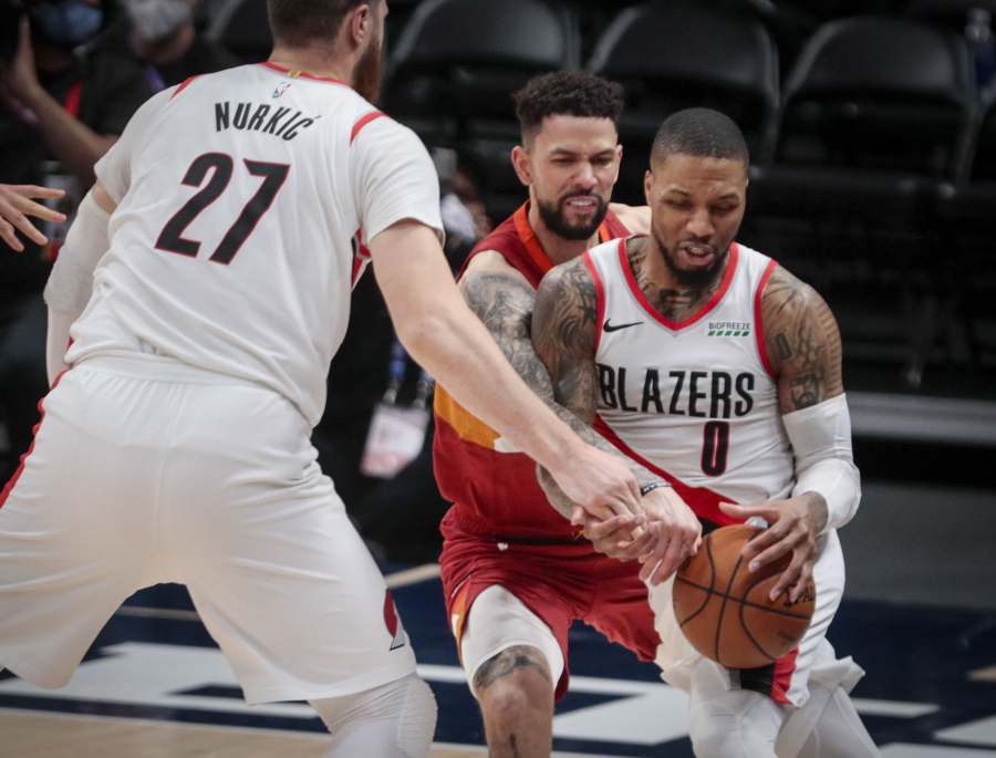 Portland Trail Blazers center Jusuf Nurkic (27) sets a screen against Denver Nuggets guard Austin Rivers as Rivers fouls Trail Blazers guard Damian Lillard (0) in the second quarter of Game 2 of a first-round NBA basketball playoff series Monday, May 24, 2021, in Denver.