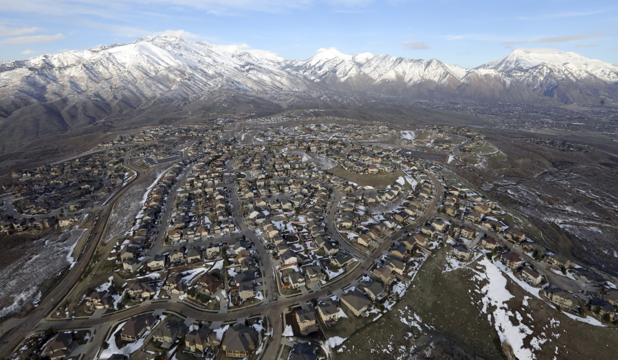 FILE - Rows of homes, in suburban Salt Lake City, on April 13, 2019. Utah is one of two Western states known for rugged landscapes and wide-open spaces that are bucking the trend of sluggish U.S. population growth. The boom there and in Idaho are accompanied by healthy economic expansion, but also concern about strain on infrastructure and soaring housing prices.