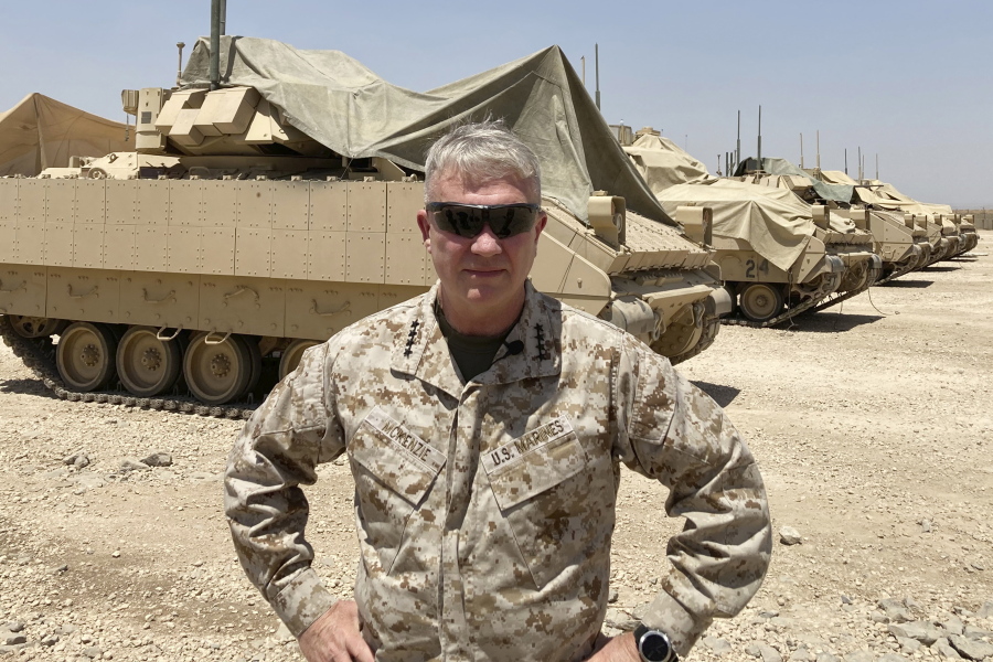 Marine Gen. Frank McKenzie, the top U.S. commander for the Middle East, speaks to the media after arriving in Syria to meet with U.S. and allied commanders and troops, Friday, May 21, 2021. The Iraqi government for the first time is expected to bring home about 100 Iraqi families from a sprawling camp in Syria next week, a move that U.S. officials see as a hopeful sign in the long-frustrated effort to repatriate thousands from the camp, known as a breeding ground for young insurgents. On an unannounced visit to Syria, McKenzie expressed optimism that the transfer from the al-Hol camp will happen. (AP Photo/Lolita C.