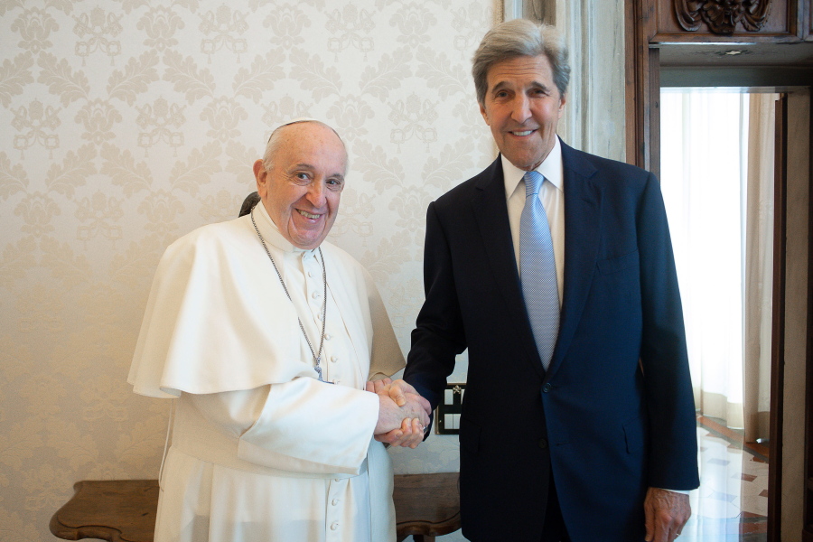 Pope Francis and John Kerry, right, shake hands as they pose for a photo at the Vatican, Saturday, May 15, 2021. Former U.S. Secretary of State John Kerry, currently President Biden's envoy on the climate, met in private audience with Pope Francis on Saturday, afterward calling the pope "a compelling moral authority on the subject of the climate crisis" who has been "ahead of the curve." Kerry told Vatican News in an interview that the pope speaks with "unique authority, compelling moral authority, that hopefull can push people to greater ambition to get the job done.
