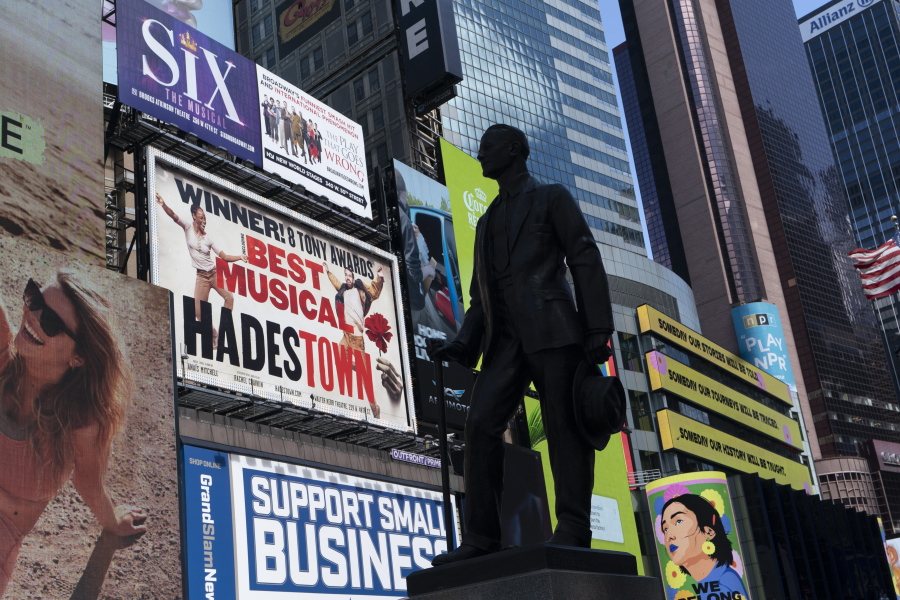 A statue of playwright and performer George M. Cohan stands in New York's Times Square in front of billboards for Broadway shows May 6.