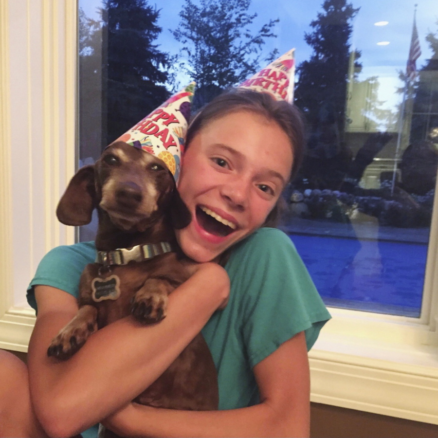 This August 2020 photo provided by Peyton Crest shows her with her dog at home in Minnetonka, Minn. The 18-year-old ays she developed anorexia before the pandemic but has relapsed twice since it began. ''It was my junior year, I was about to apply for college,'' Crest says. Suddenly deprived of friends and classmates, her support system, she'd spend all day alone in her room and became preoccupied with thoughts of food and anorexic behavior.