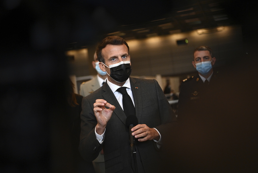 French President Emmanuel Macron talks to the press as he visits a giant vaccination center against the Covid-19 during its inauguration at Porte de Versailles convention centre in Paris, Thursday, May 6, 2021.
