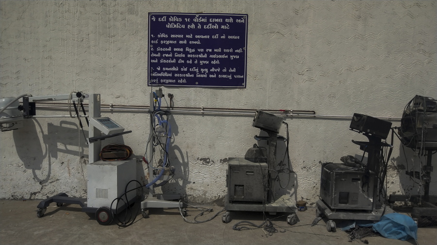Instructions for COVID-19 patients are seen on a signage in Gujarati next to damaged equipments after a deadly fire at the Welfare Hospital in Bharuch, western India, Saturday, May 1, 2021. The fire in a COVID-19 ward of the hospital killed multiple patients early Saturday, as the country grappling with the worst outbreak yet steps up a vaccination drive for all its adults even though some states say don't have enough jabs.