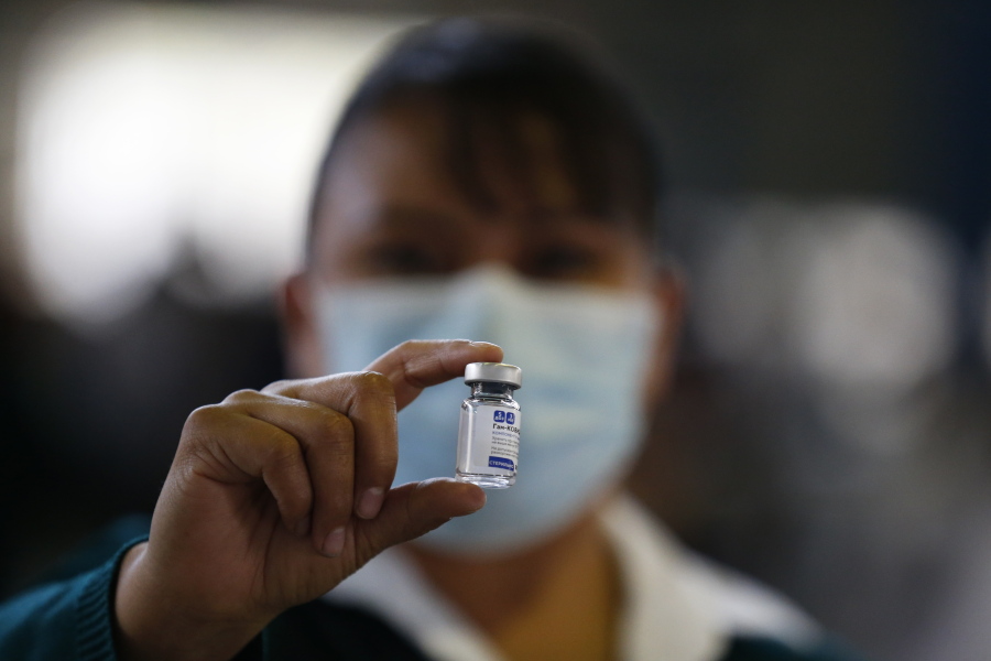 FILE - In this Feb. 24, 2021 file photo, a medical worker holds up a vial of the Sputnik V coronavirus vaccine, as the city health department conducts a mass vaccination campaign for Mexicans over age 60, at Palacio de los Deportes in Mexico City. Mexico will begin bottling and packaging the Russian vaccine, Mexico Foreign Affairs Secretary Marcelo Ebrard said Wednesday, April 28, 2021, during a visit to Russia.