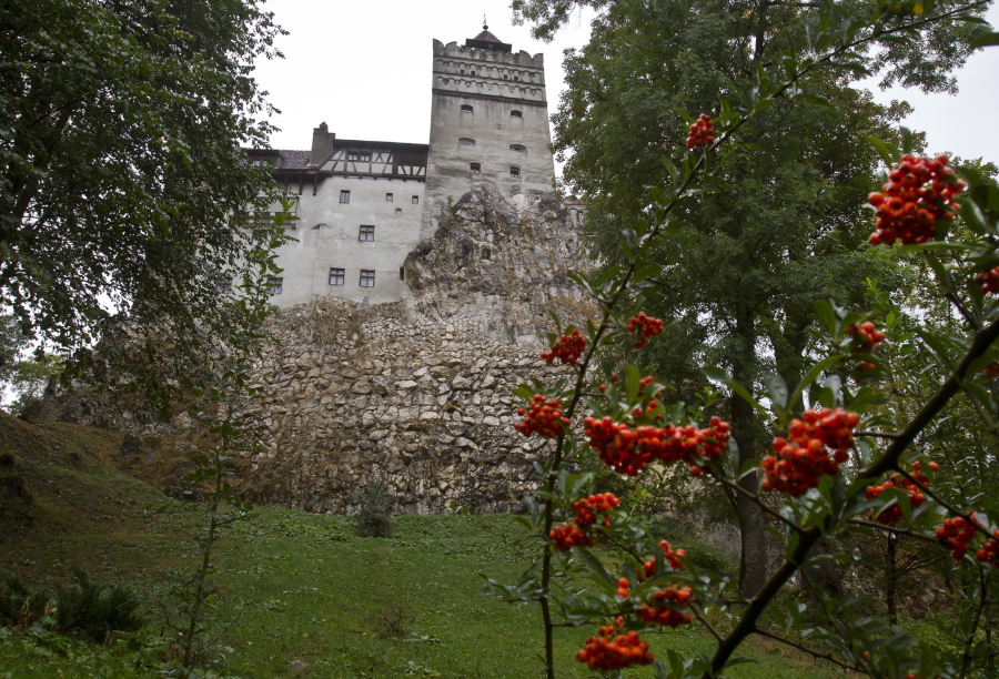 FILE - In this Saturday, Oct. 8, 2011 file picture, the Gothic Bran Castle, better known as Dracula Castle, is seen on a rainy day in Bran, in Romania's central Transylvania region. Romanian authorities have set up a COVID-19 vaccination center in a medieval building in Bran, not far from the castle, as a means to encourage people to vaccinate and also to boost tourism which has decreased in the area as a result of the pandemic.