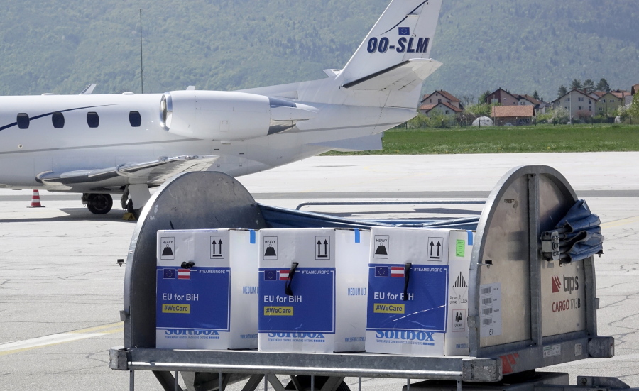 FILE - In this May 4, 2021, file photo, a container with boxes of the Pfizer vaccine for COVID-19 is delivered at the Sarajevo Airport, Bosnia. The head of the World Trade Organization said Friday, May 7, the U.S. administration's call to remove patent protections on COVID-19 vaccines could help expand fair access to vaccines but might not be the most "critical issue," as officials in Europe increasingly insisted that more vaccine exports are the more pressing priority.