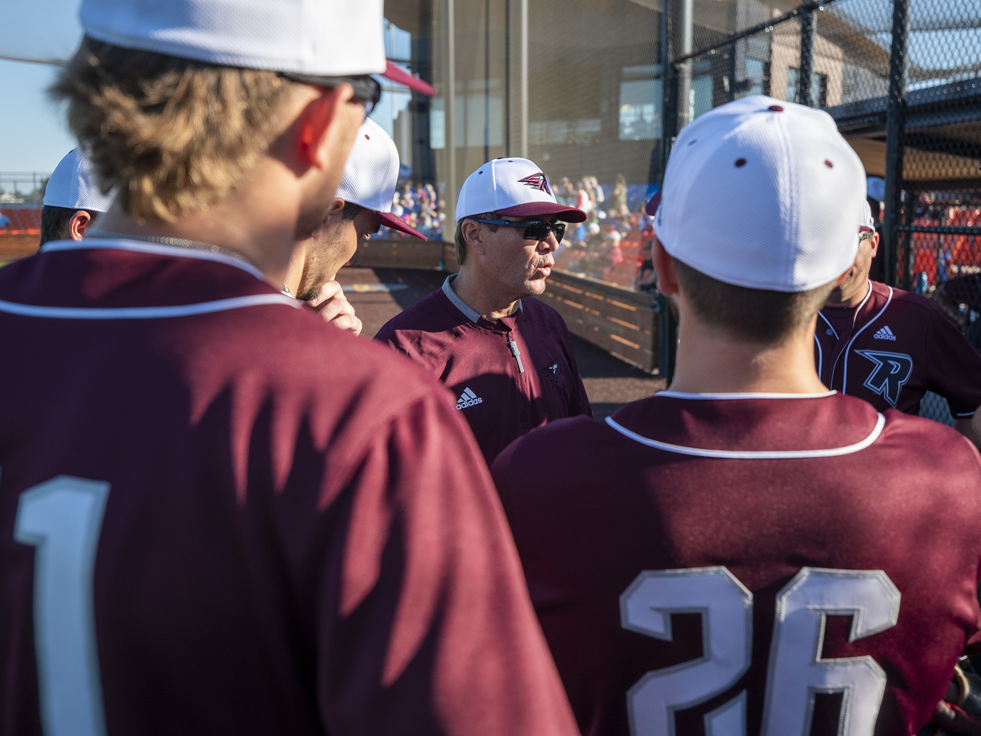 Ridgefield head coach Chris Cota, center, talks to the team Wednesday, June 2, 2021, before the Raptors' game against the Cowlitz Black Bears at the Ridgefield Outdoor Recreation Complex.