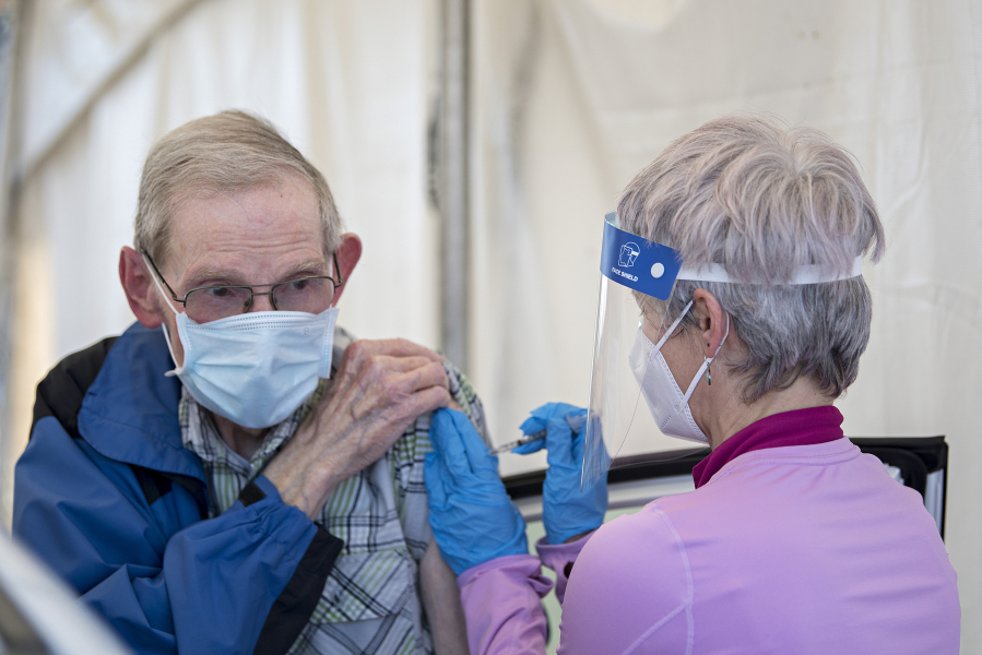 Vancouver resident Dennis Marlowe gets his second vaccination dose from Safeway pharmacist Kristen Morin at the Tower Mall vaccination site in Vancouver on April 5. Vaccinations are available without an appointment at the site, which will close June 29.