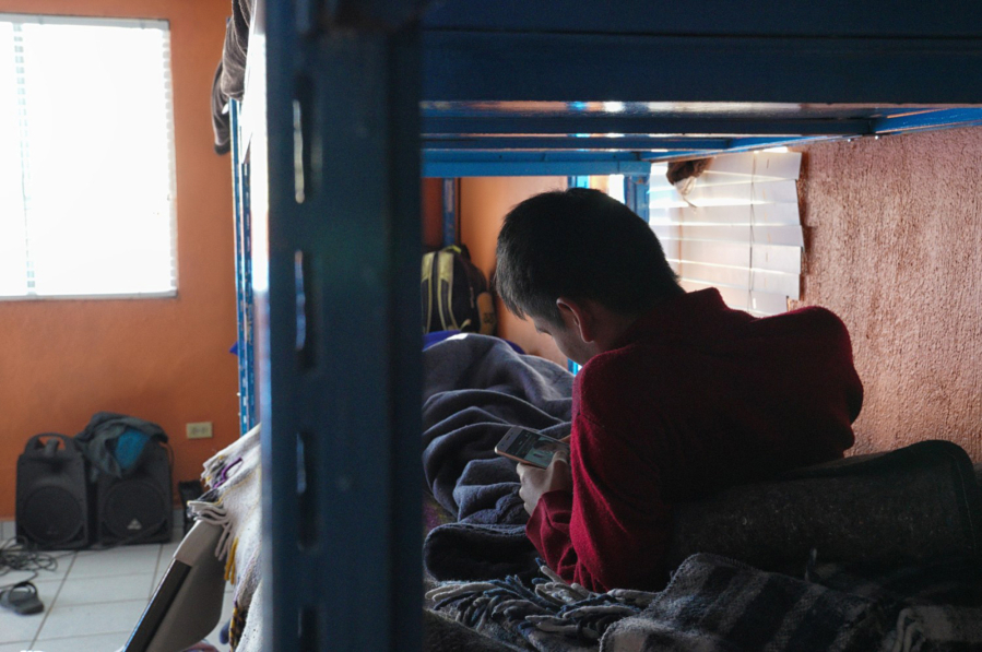 On Thursday January 9, 2020 at YMCA Homes for the Migrant Youth in Tijuana, Mexico, two boys relax on their bunk beds as they look over various social medias sites on their smart phones. The two boys are among the small group of unaccompanied youths staying at the shelter hoping to cross north into the United States. (Nelvin C.