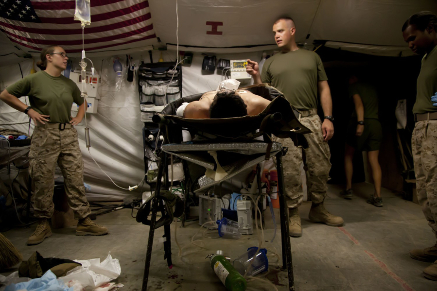 In June 2012, medical personnel at Forward Operating Base Edinburgh, in Helmand Province, discuss a patient???s case. (Nelvin C.