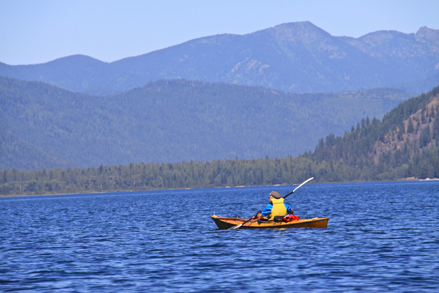 This undated photo shows a kayaker paddling across Upper Priest Lake, Idaho, to a remote campground. Idaho has doubled fees for out-of-state campers.