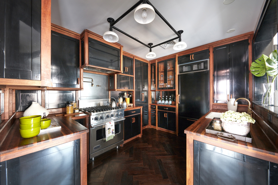 Black cabinets trimmed in walnut make an elegant statement in this kitchen.