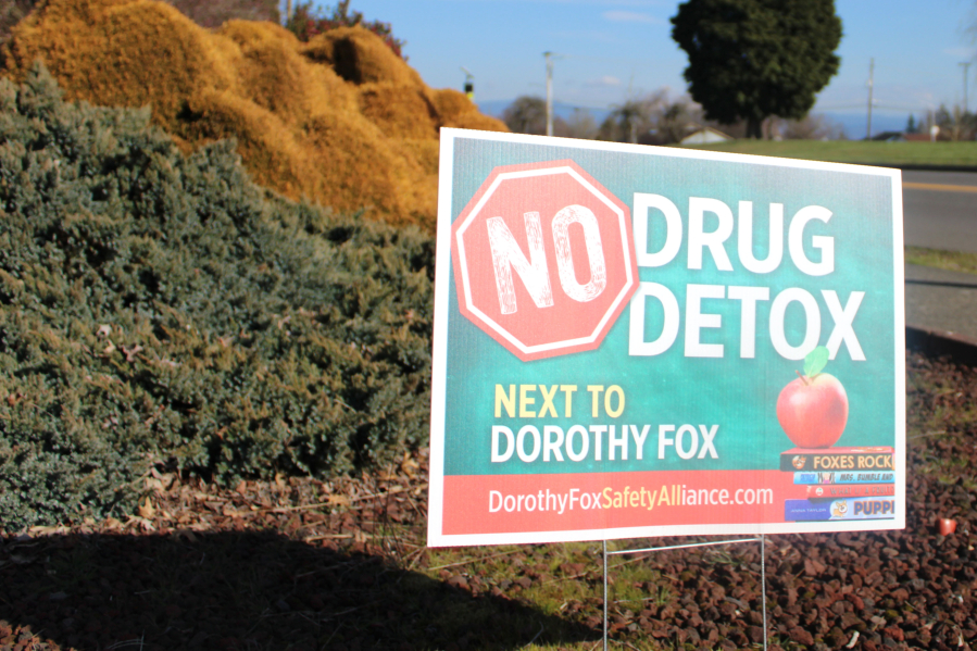 A "No Drug Detox Next to Dorothy Fox" sign stands at the corner of Northwest 28th Avenue and Northwest Utah Street, across from the Camas elementary school.